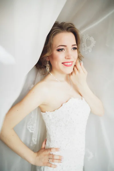 Noiva de luxo em vestido branco posando enquanto se prepara para a cerimônia de casamento — Fotografia de Stock