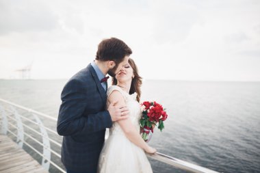 Denizin üzerinde bir iskele üzerinde duran evli evlilik çift