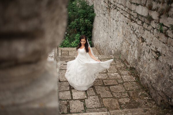 Gorgeous romantic gentle stylish beautiful caucasian bride on the background ancient baroque castle.
