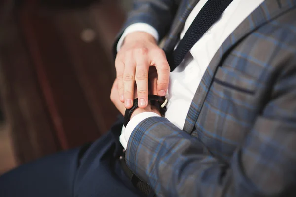 Впевнений бізнесмен, дивлячись на його наручний годинник у костюмі — стокове фото