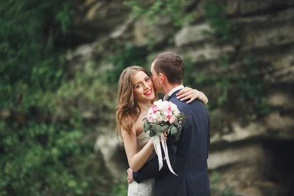 Szczęśliwy wesele para przytulanie i uśmiechając się nawzajem na tle przepięknych roślin w zamku — Zdjęcie stockowe