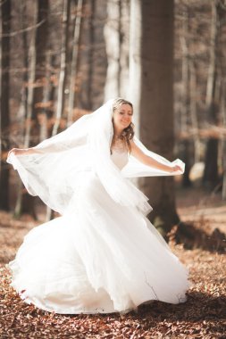 Buket tutarak ve orman poz şık elbiseli güzel gelin