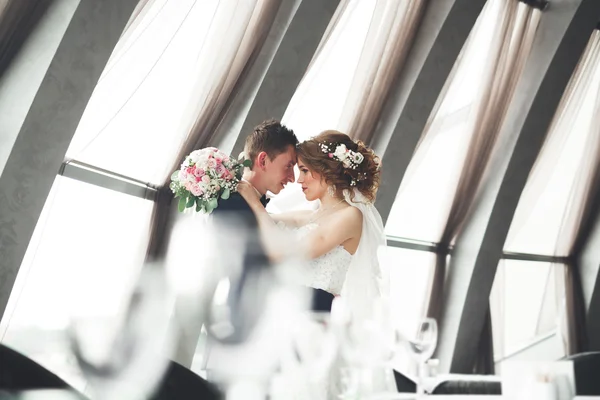 Hochzeitspaar steht und küsst sich im Hotel — Stockfoto