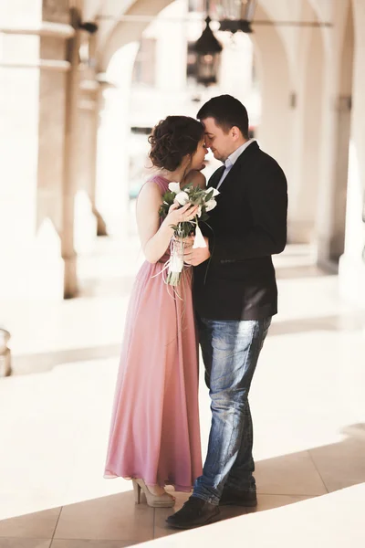Pareja romántica de la boda, hombre y mujer, posando cerca de la columna del edificio viejo —  Fotos de Stock