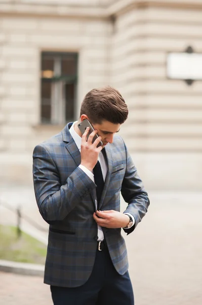 Elegante jovem empresário falando ao telefone ao ar livre — Fotografia de Stock