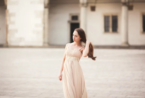 Beautiful girl, model with long hair posing in old castle near columns. Krakow Vavel — Stock Photo, Image