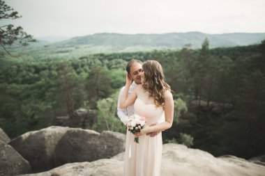 Muhteşem gelin, damat öpüşme ve sarılma Gösterim çarpıcı uçurum yakın: