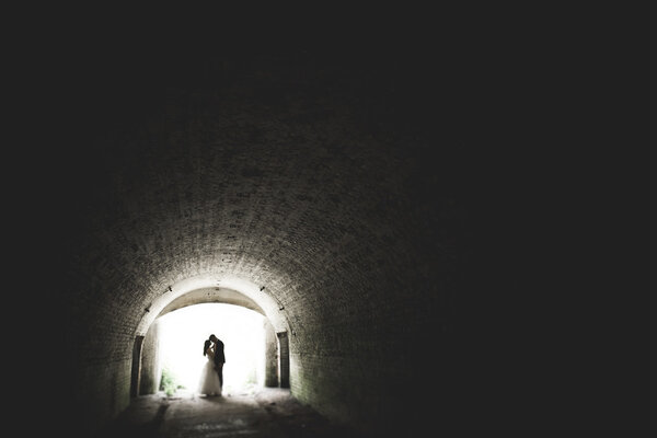 Happy newlyweds near the ancient castle on the walk