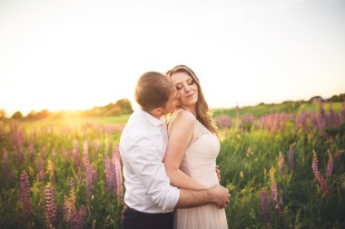 Çiçekli alan üzerinde yürüyen genç Düğün çifti