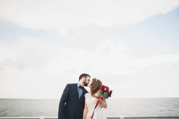Одружена весільна пара стоїть на причалі над морем — стокове фото
