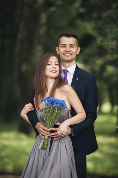 Handsome young couple posing outdoors after ceremony — Stock Photo, Image