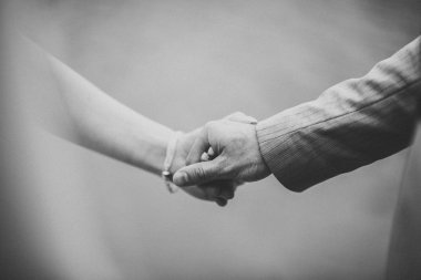 Gelin ve damat el ele tutuşuyor.