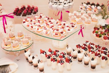 Different kinds of baked sweets on a buffet clipart