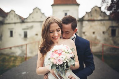 Mutlu düğün kaç sarılma ve birbirlerine arka plan eski kale üzerinde gülümseyen