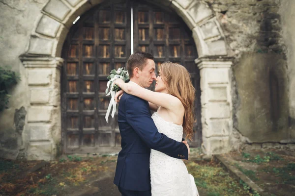 Mutlu düğün kaç sarılma ve birbirlerine arka plan eski kale üzerinde gülümseyen