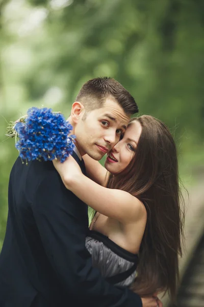 Bonito jovem casal posando ao ar livre após a cerimônia — Fotografia de Stock
