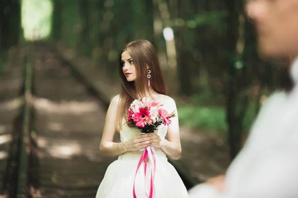 Retrato de close-up de noiva bonita com buquê de casamento isolado no fundo verde campo de verão natural — Fotografia de Stock