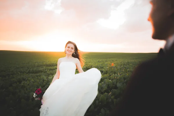 Closeup portrait of beautiful bride with wedding bouquet isolated at green natural summer field background — Stock Photo, Image