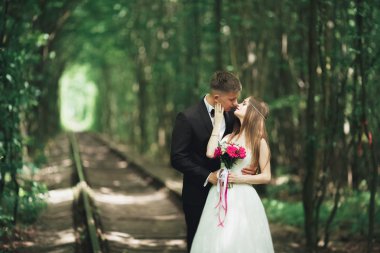 Genç düğün çift, gelin ve damat bir demiryolundan poz