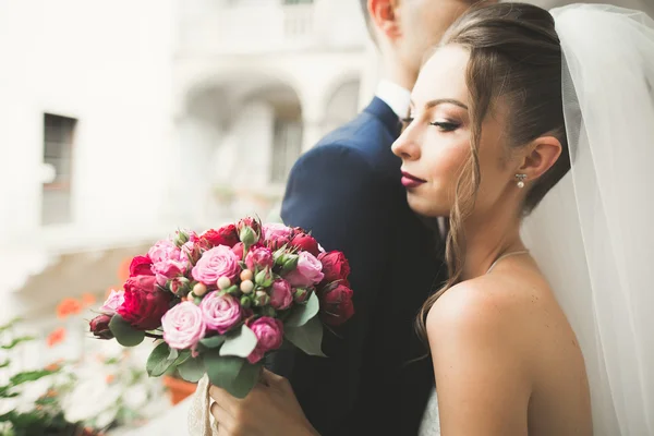 Portrait of happy newly wedding couple with bouquet — Stock Photo, Image