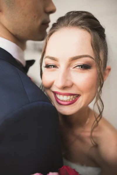 Retrato de feliz pareja de recién casados con ramo de flores — Foto de Stock