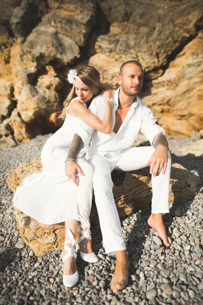 Fashion model couple with tattoo posing outside nea sea