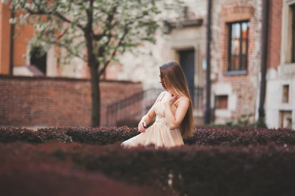 Hermosa mujer feliz en el parque un cálido día de primavera sentado en el banco —  Fotos de Stock