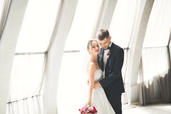 Hermosa pareja, novia y novio posando en el balcón con el fondo de la ciudad vieja —  Fotos de Stock