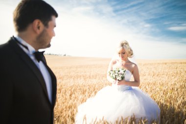 Duygusal güzel gelin, yeni evli damada yakın planda sarılıyor.