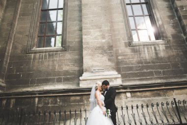 Güzel, mutlu bir düğün çifti, güzel şehirde uzun beyaz elbiseli bir gelin.