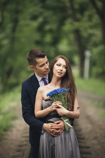 Bonito jovem casal posando ao ar livre após a cerimônia — Fotografia de Stock