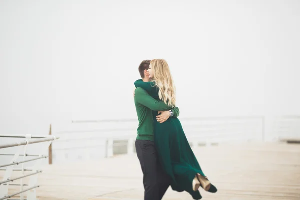 Adorável casal beijando e abraçando em uma doca do mar — Fotografia de Stock