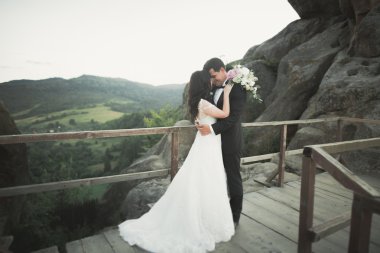 Muhteşem gelin, damat öpüşme ve sarılma Gösterim çarpıcı uçurum yakın: