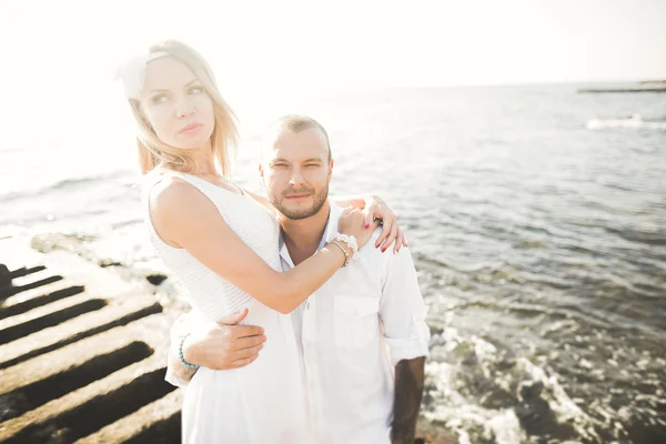 Happy romantic fashion couple in love have fun on beautiful sea at summer day