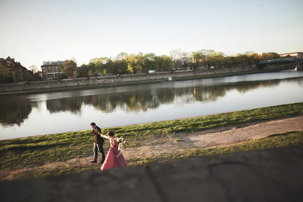 Beautiful unique couple walks into your wedding day in Krakow near river Visla — Stock Photo, Image