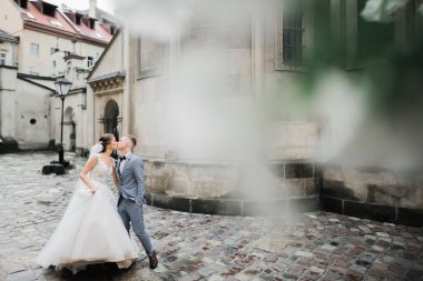 Güzel gelin ve damat evlendikleri gün kucaklaşıp öpüşüyorlar.