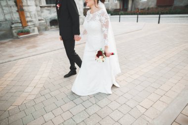 Gelin ve damat el ele tutuşuyor.