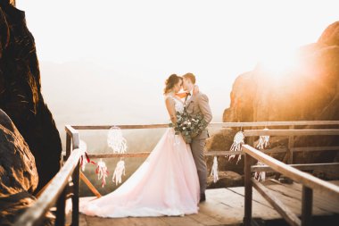 Düğün gününde damadın ve gelinin dağların eteklerinde mutlu mesut evlenecekler. Doğada mutlu evlilikler, yumuşak güneşli ışıklar.