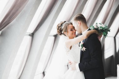 Mükemmel bir çift gelin ve damat düğün günlerinde poz verip öpüşürler.