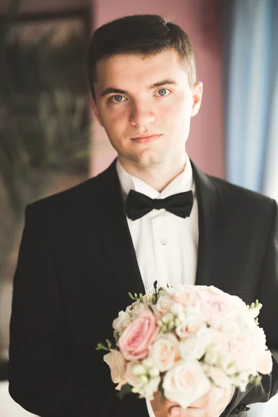 Young handsome man relaxing at his apartment in a hotel after business meeting — Stock Photo, Image