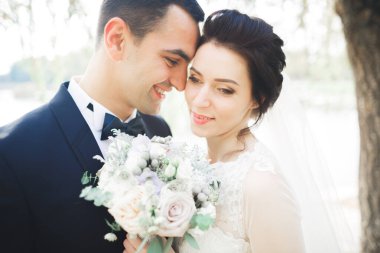 Yeni evli çift el ele tutuşurken parkta koşup zıplıyorlar.