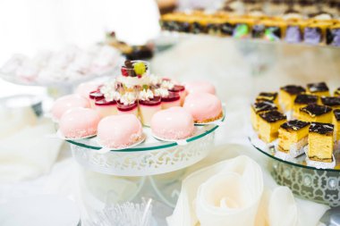 Lezzetli ve tatlı bir tatlı masası. Kapalı resepsiyonda küçük kekler ve shot 'lar var.