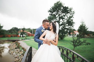 Parkta kucaklaşan yeni evli çiftin güzel romantik düğünü.