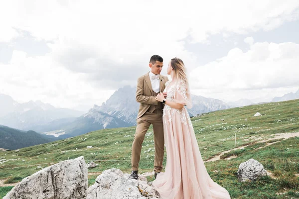 Hermosa novia hermosa posando para el novio y divertirse cerca de las montañas con una vista increíble, espacio para el texto, pareja de boda —  Fotos de Stock