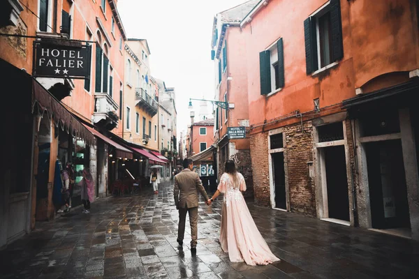 Ślub para trzymając się za ręce, pan młody i panna młoda razem w dniu ślubu w Wenecji, Włochy — Zdjęcie stockowe