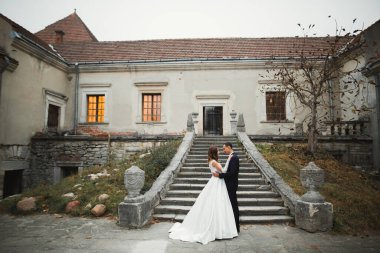 Göz kamaştırıcı mutlu çift birbirine yakın duruyor ve gözlerinin içine bakıyor.