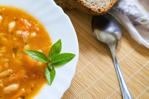 Cooked beans served in white plate — Stock Photo, Image