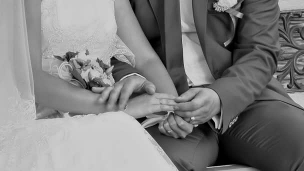 The groom gently stroking the right hand of the bride — Stock Video