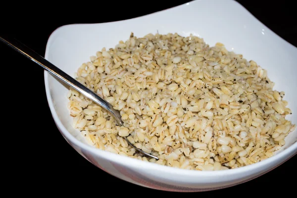 Puffed wheat bowl isolated on black background — Stock Photo, Image