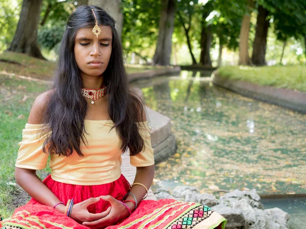 A gyakorlás a meditáció, a park gyönyörű fiatal nő indiai — Stock Fotó